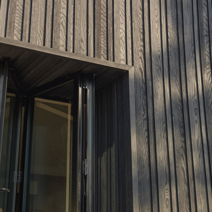 Millboard Board and Batten cladding in Burnt Cedar
