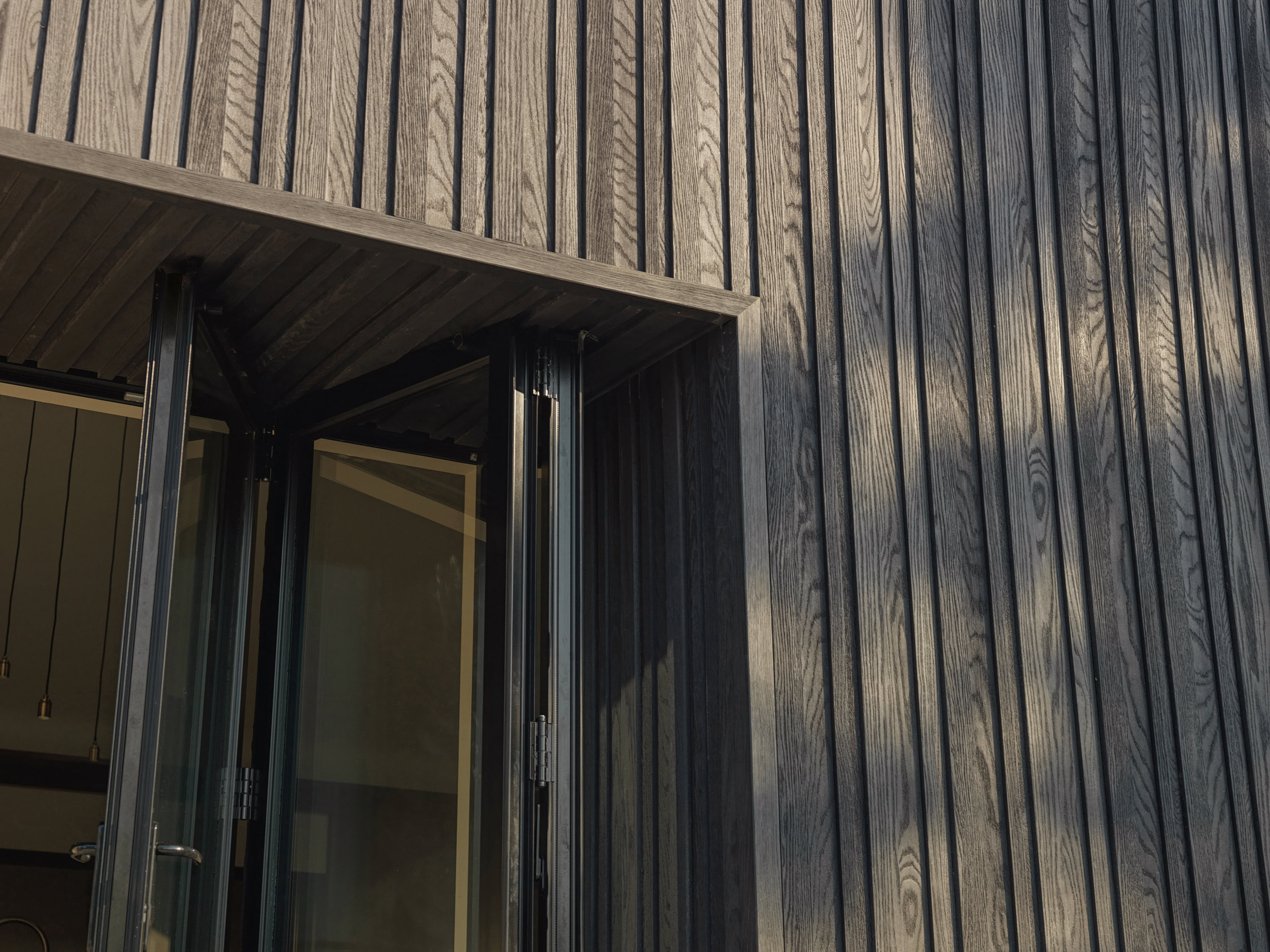 Millboard Board and Batten cladding in Burnt Cedar