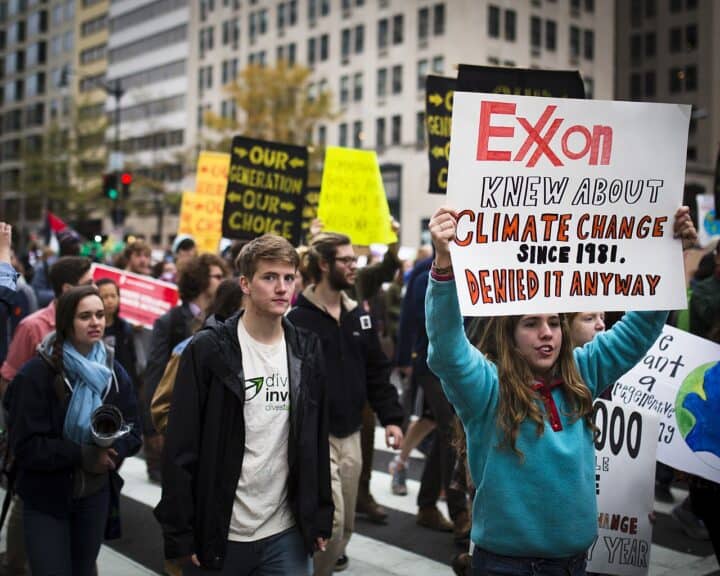 Clean energy. Climate protest with signs that say, exxon jnew