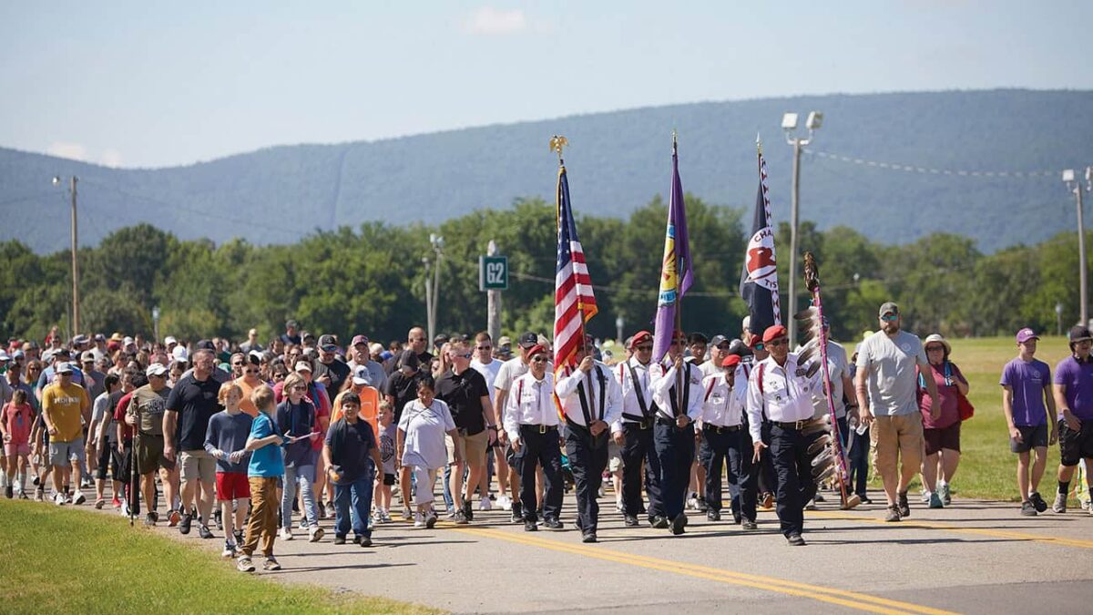 The Choctaw Nation Color Guard lead a large crowd.