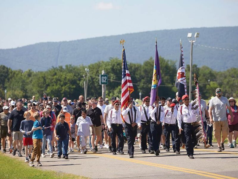 The Choctaw Nation Color Guard lead a large crowd.