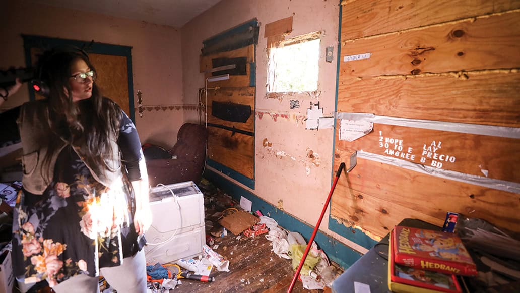 Ashton Wilson stands in her old home near where she slept.