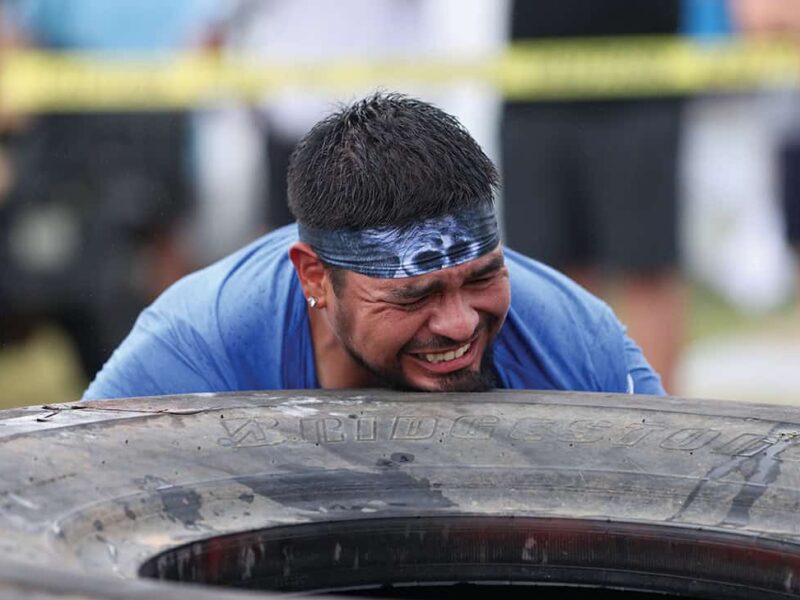 Last year's Tough Tough champion, Matt Harjo, tries to flip the 600lb tire during the 2024 Tough Tough event.
