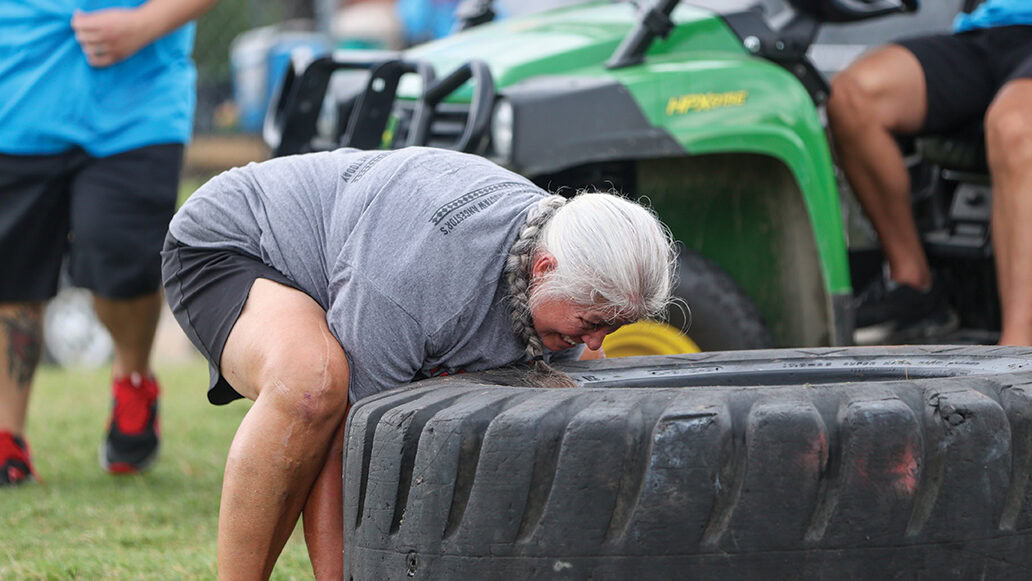 Ruby Murphy tries to flip the tire during the Tough Tough event.