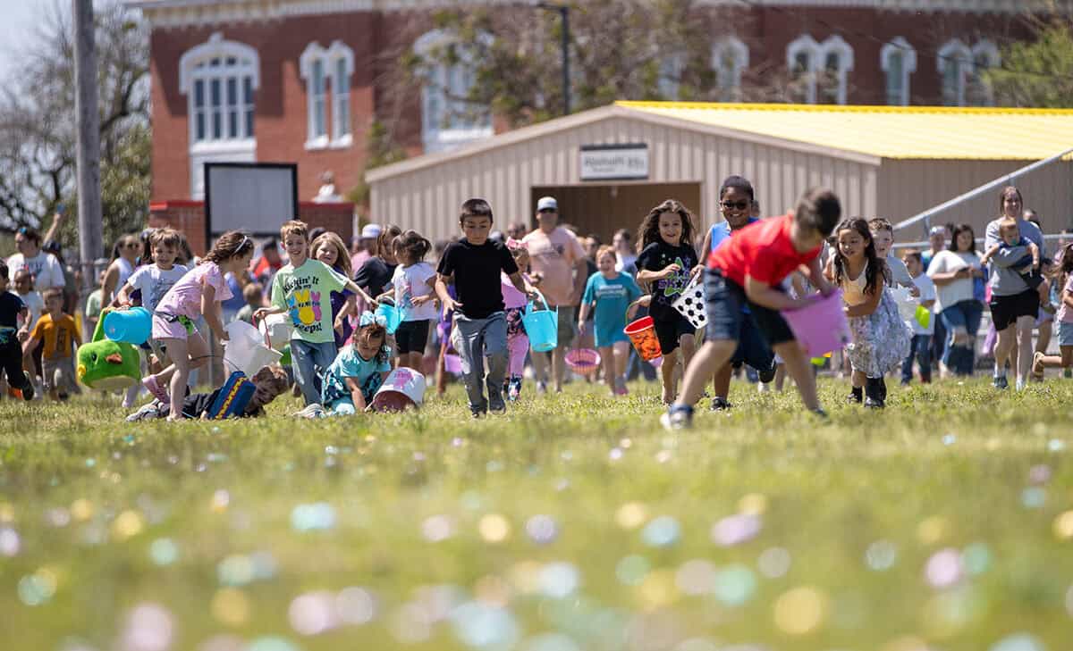 Kids rush to collect Easter eggs.