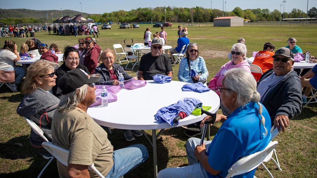 A group of adults at a table with easter eggs.