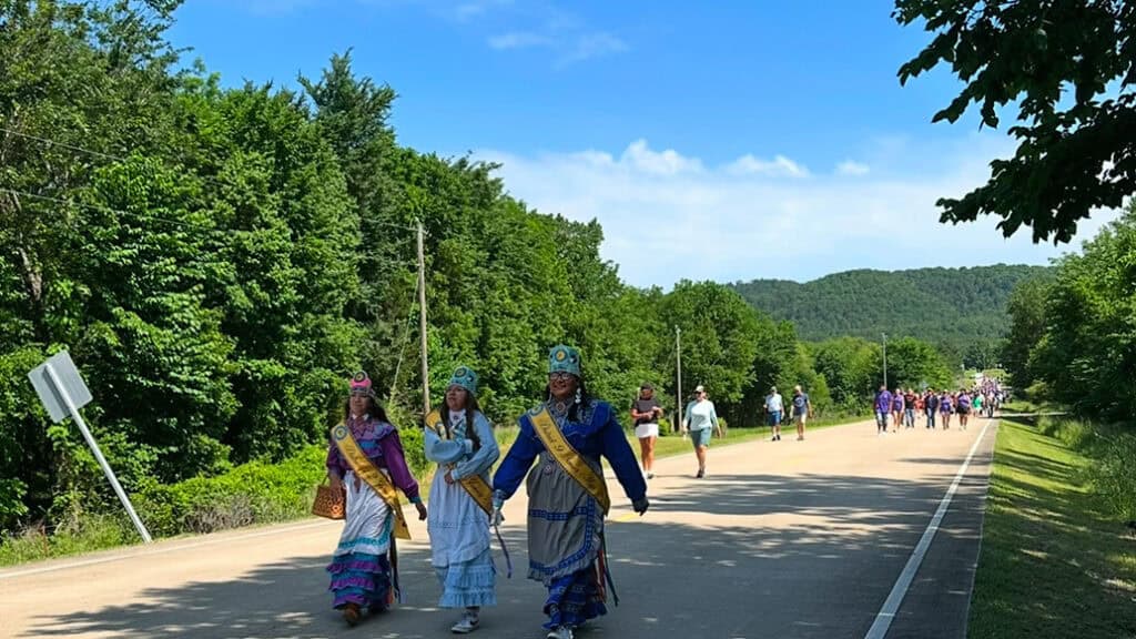 Choctaw Royalty walk by in traditional regalia.