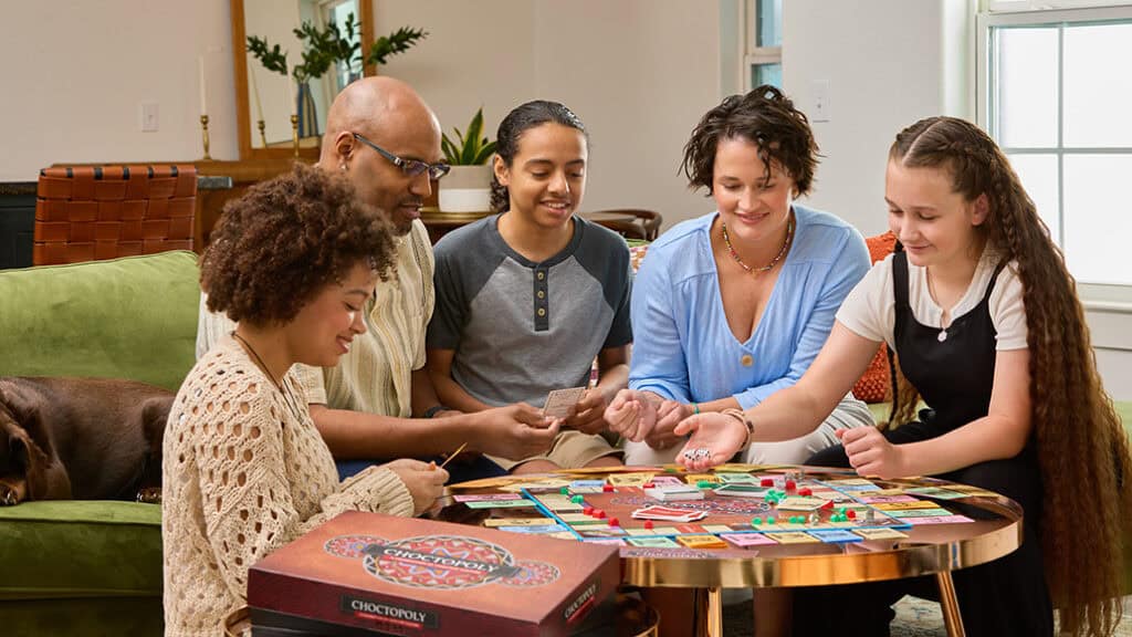 A group of people play the new Choctopoly game.