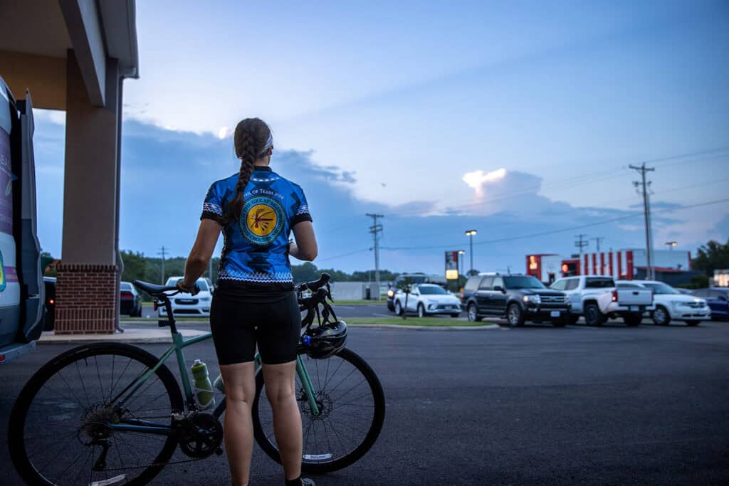 A women looks out at early morning storm clouds.