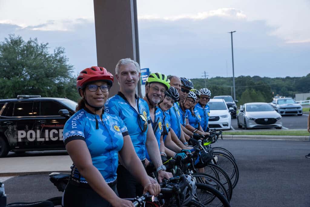Cyclists pose for a photo.