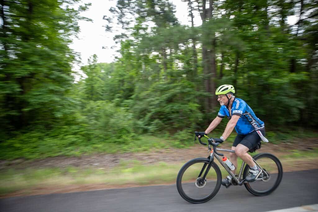 A man rides his bike.
