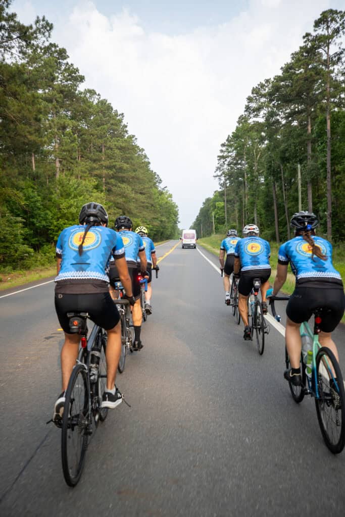 Cyclists ride their bikes.
