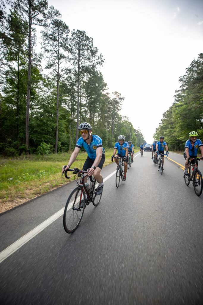 Cyclists ride their bikes.
