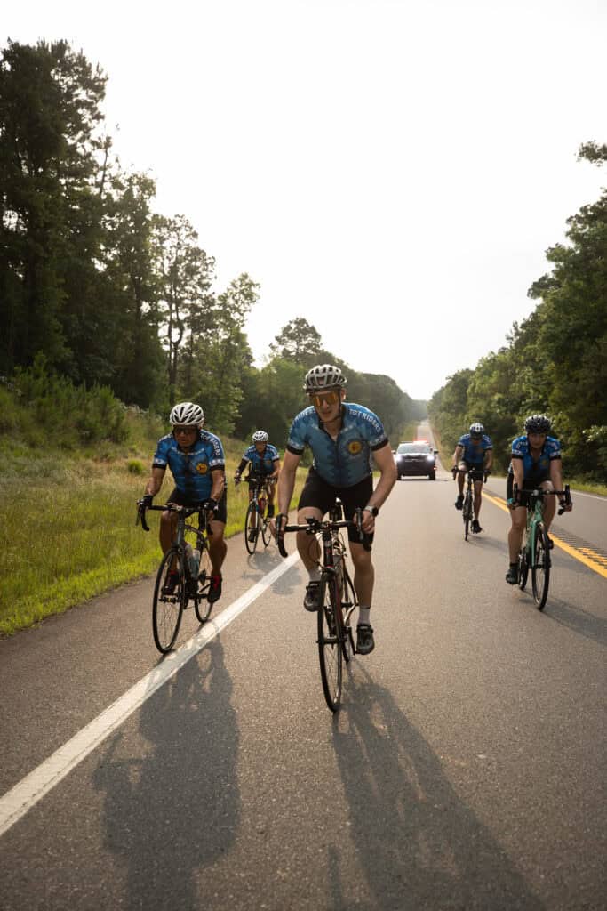 Cyclists ride their bikes.