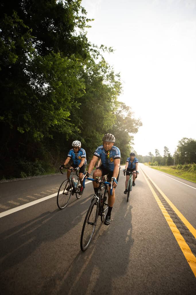A group of cyclists ride their bikes.