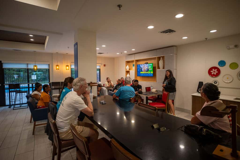 A group gathers in a hotel lobby.