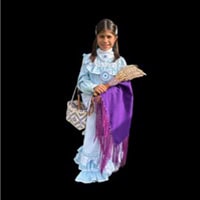 Young girl stands holding a basket and shaw, in a light blue and white traditonal dress