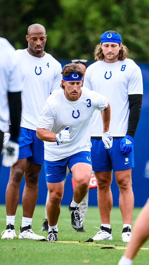 A man runs on a football field.