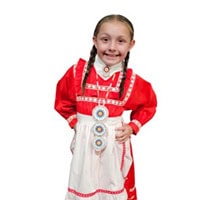 Young girl stand, smiling, wearing a red and white traditional dress.