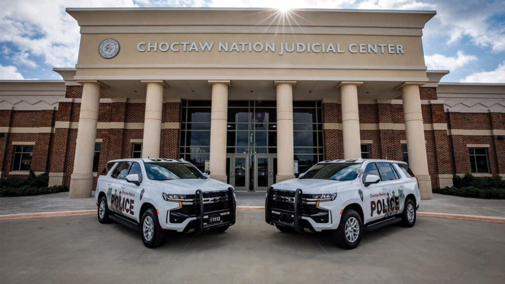 Two tribal police cars sit in front of the Choctaw judicial building.