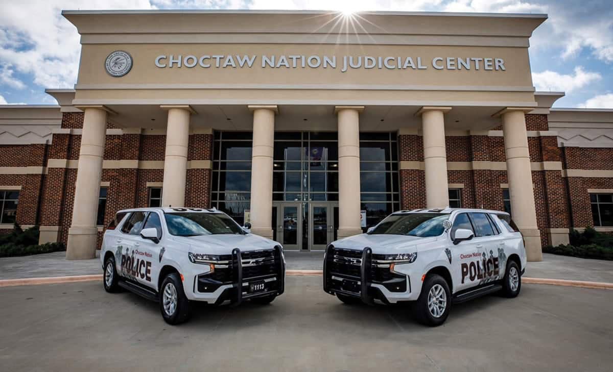 Two tribal police cars sit in front of the Choctaw judicial building.