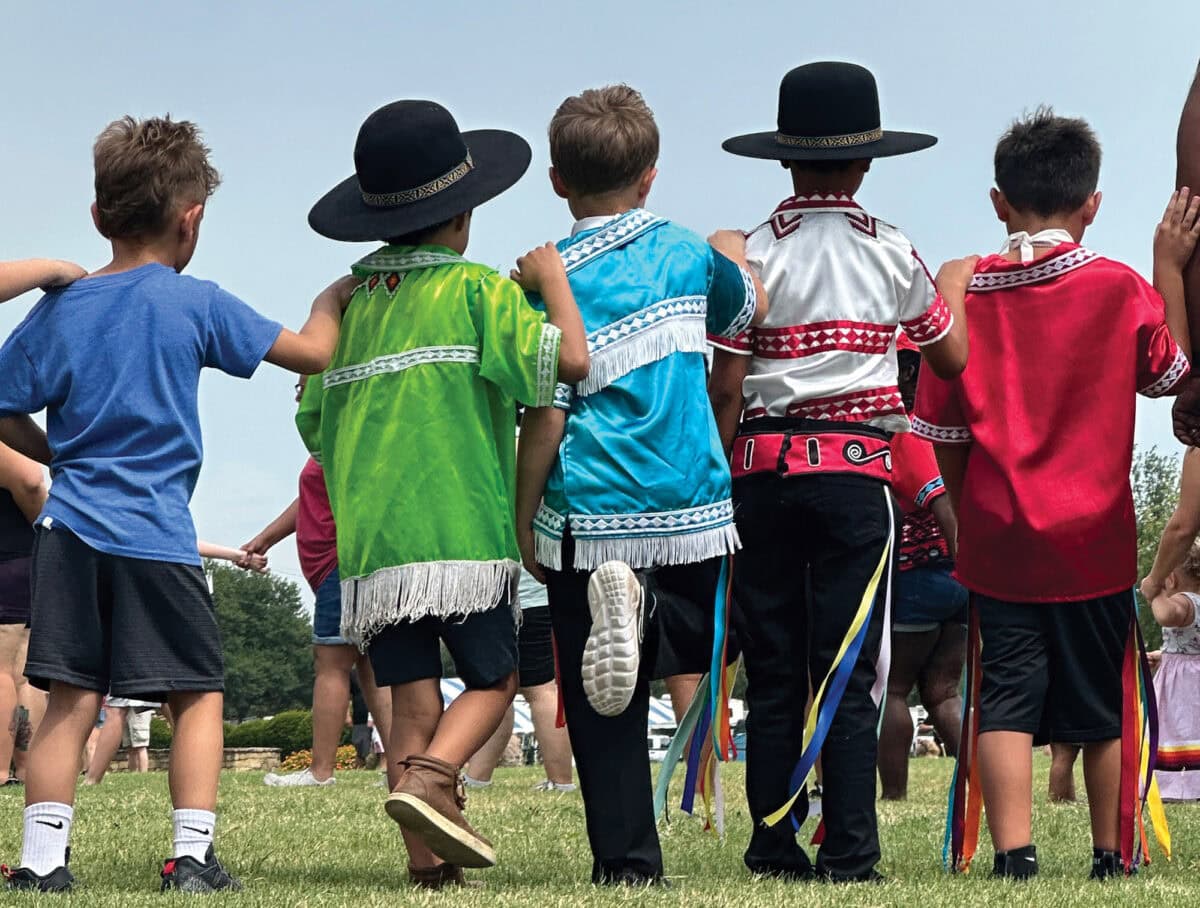 Young boys in traditional regalia participate in a Choctaw social dance.