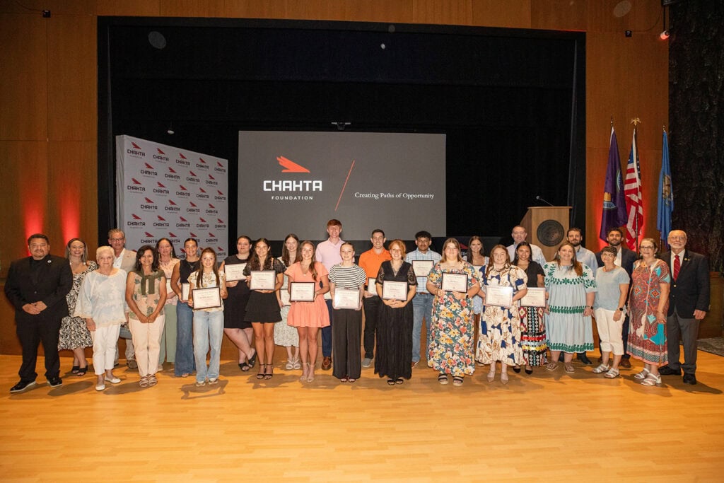 A large group of people pose for a photograph.