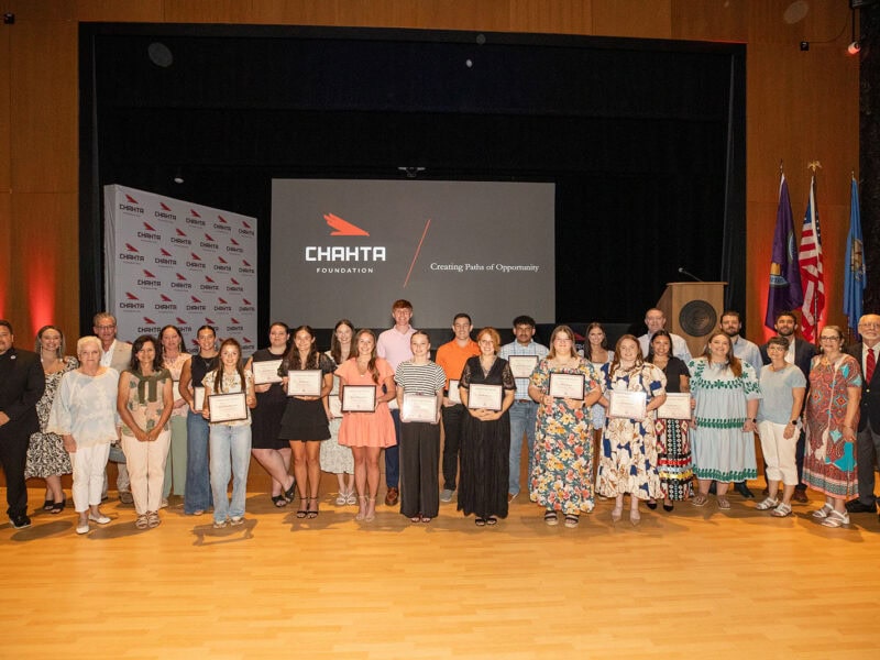 A large group of people pose for a photograph.