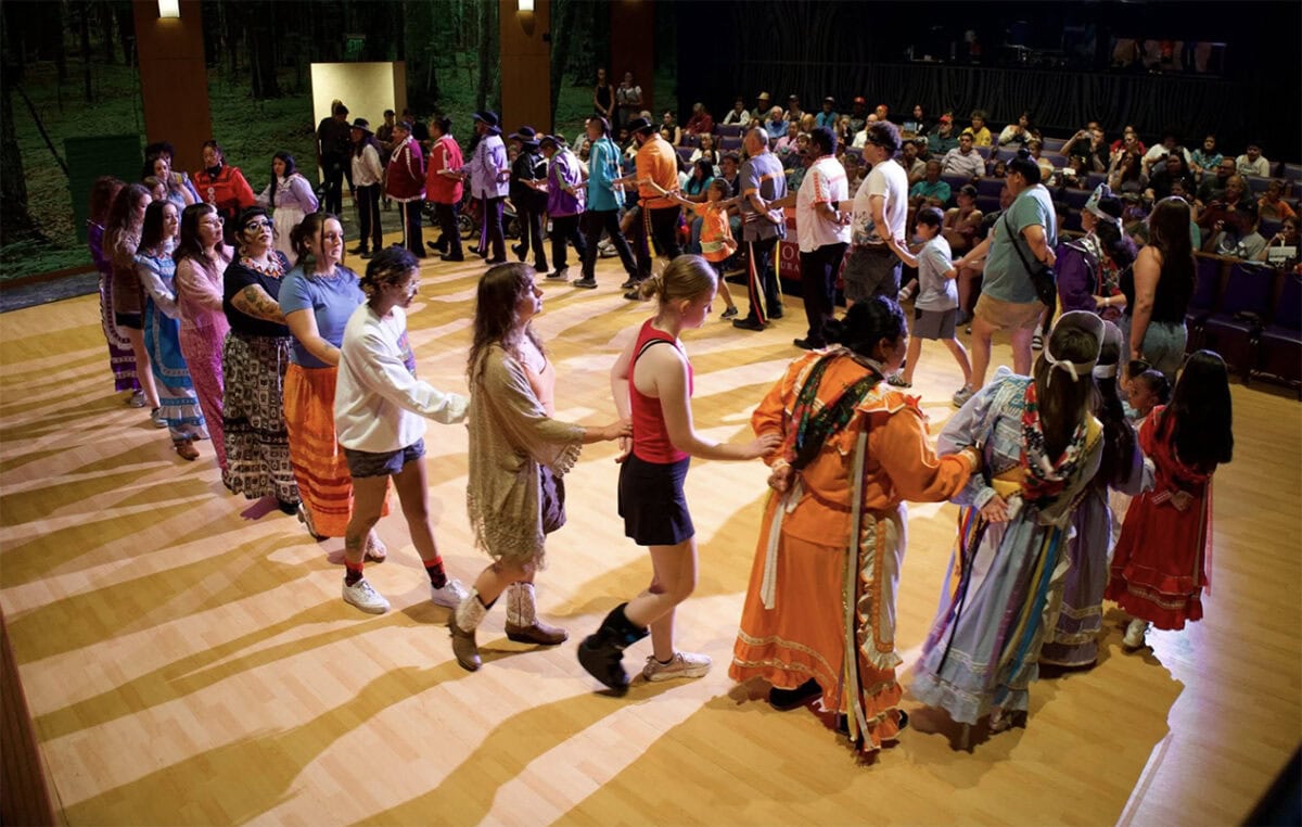Several people perform a traditional Choctaw dance.
