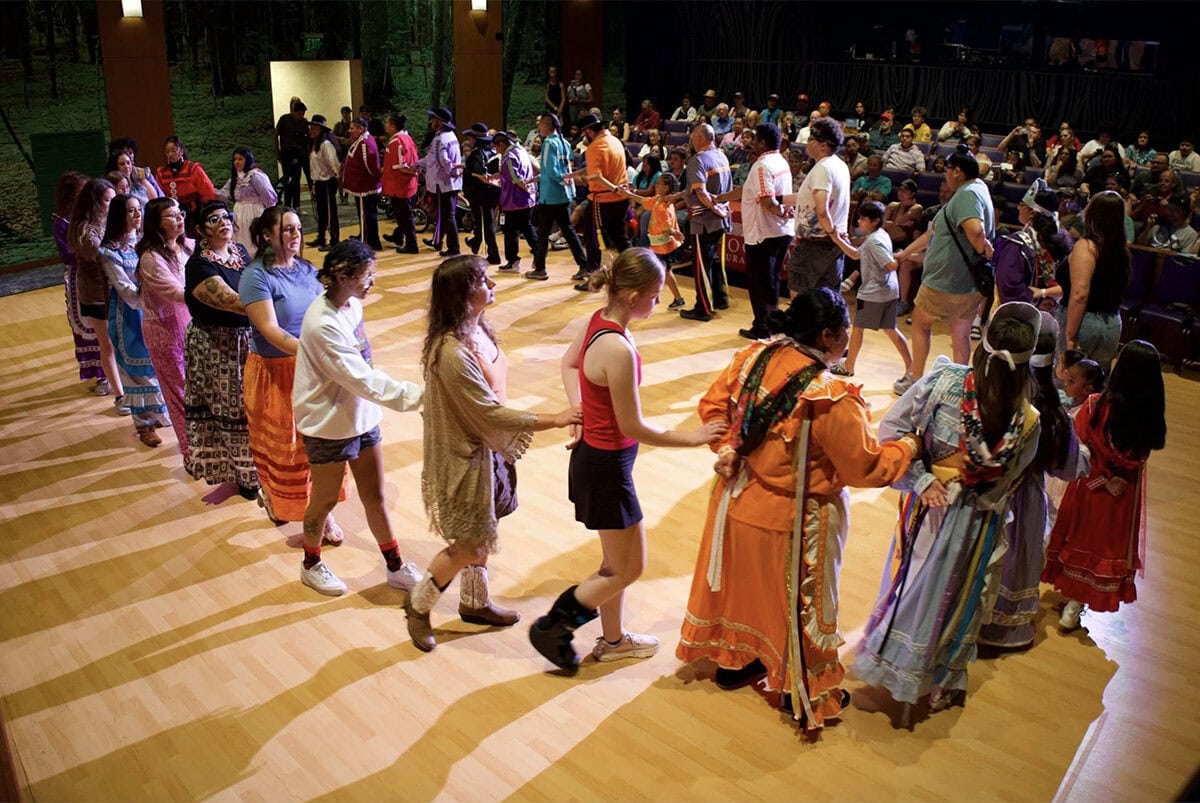 Several people perform a traditional Choctaw dance.