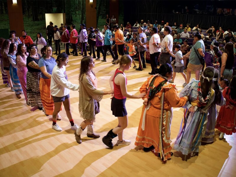 Several people perform a traditional Choctaw dance.