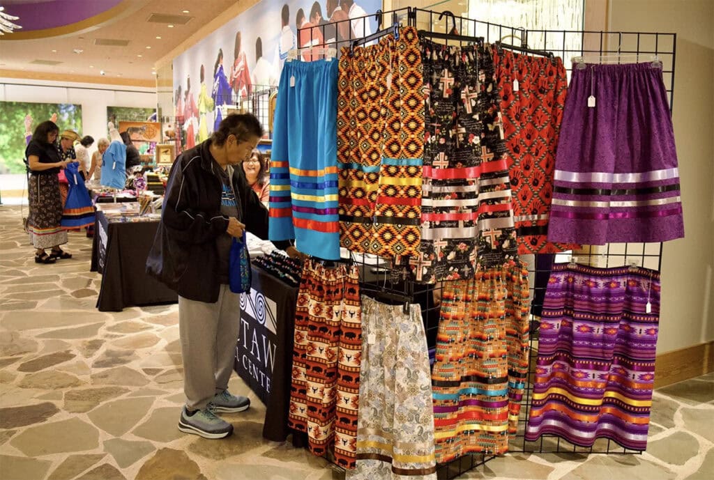 A women looks over ribbon skirts for sale.