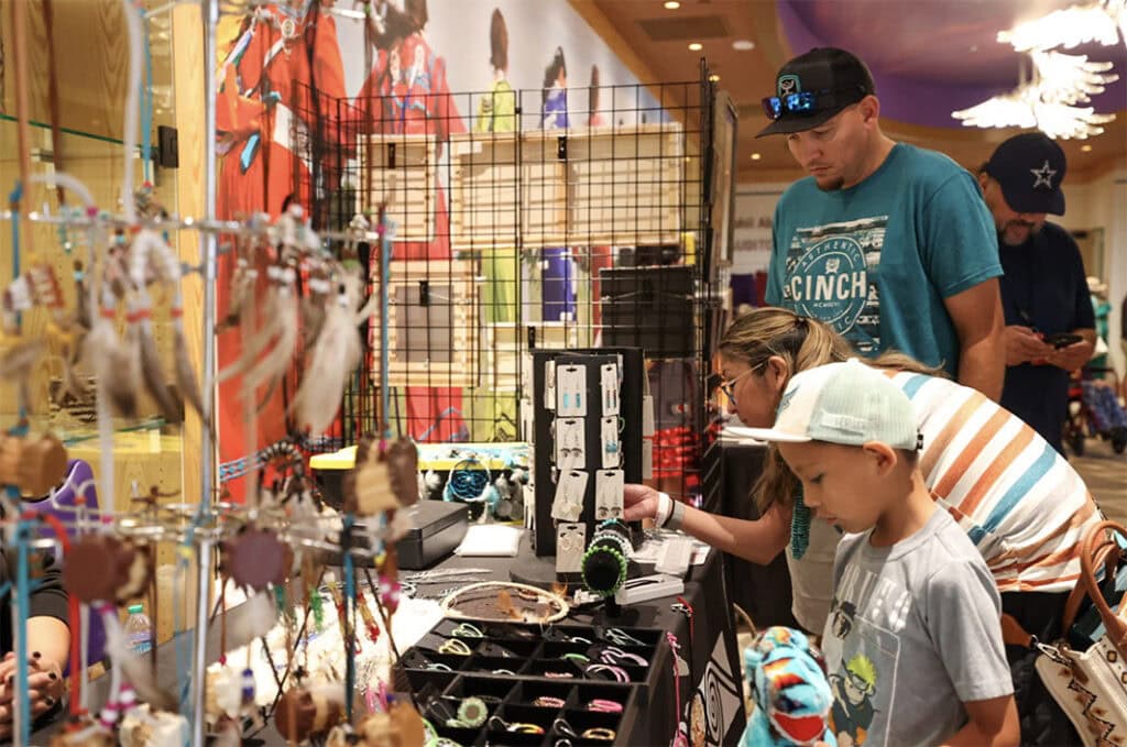 People look over crafts on display for sale.