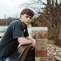 A young man poses for the camera.