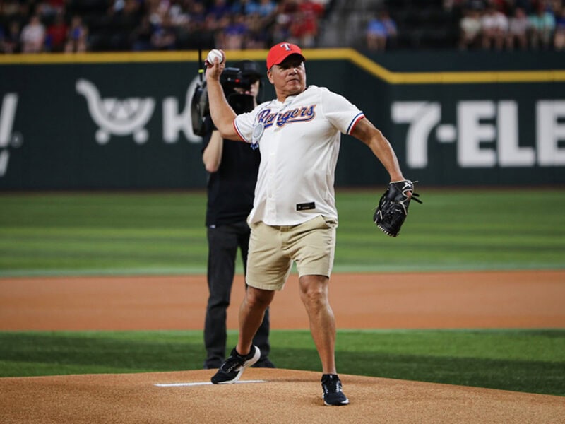 A man throws a baseball pitch.