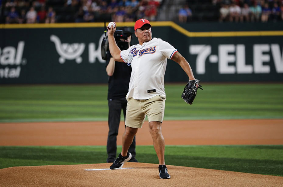 A man throws a baseball pitch.