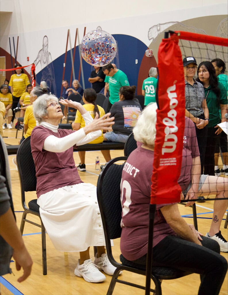 Elders play chair volleyball.