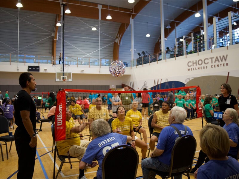Elders play chair volleyball.