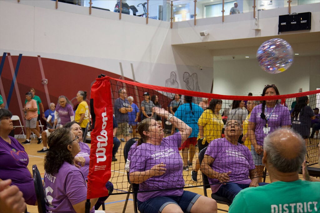 Elders play chair volleyball.