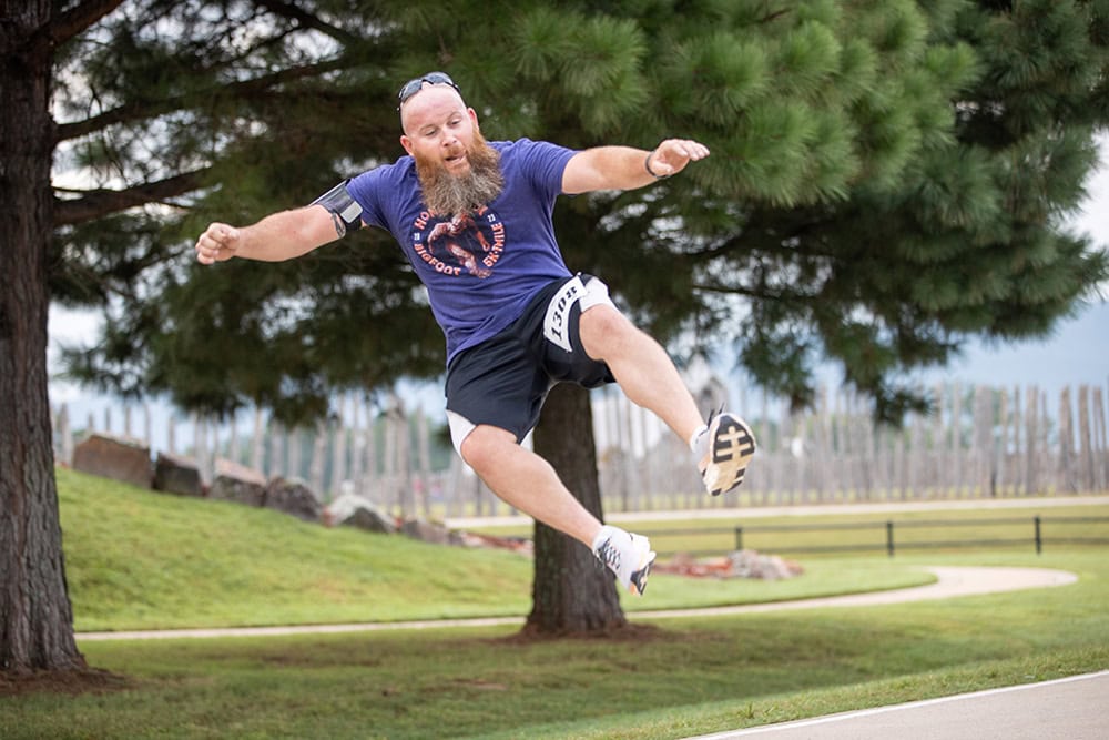A man jumps a clicks his heels in the air.