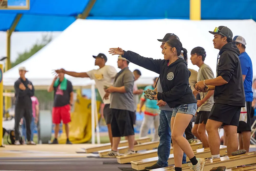 Contestants compete in the cornhole tournament.