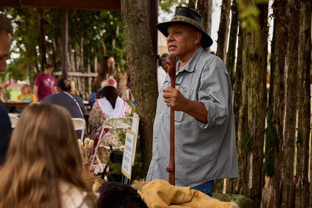 A man speaks to a group of people.