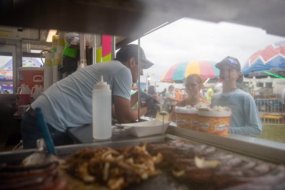 Two kids make their carnival food selection.