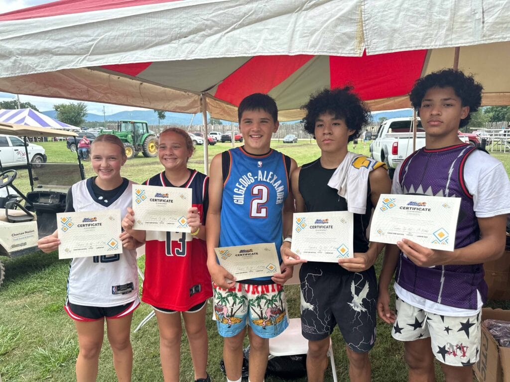 A group of people pose for a photo holding awards.