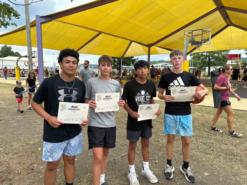 A group of people pose for a photo holding awards.