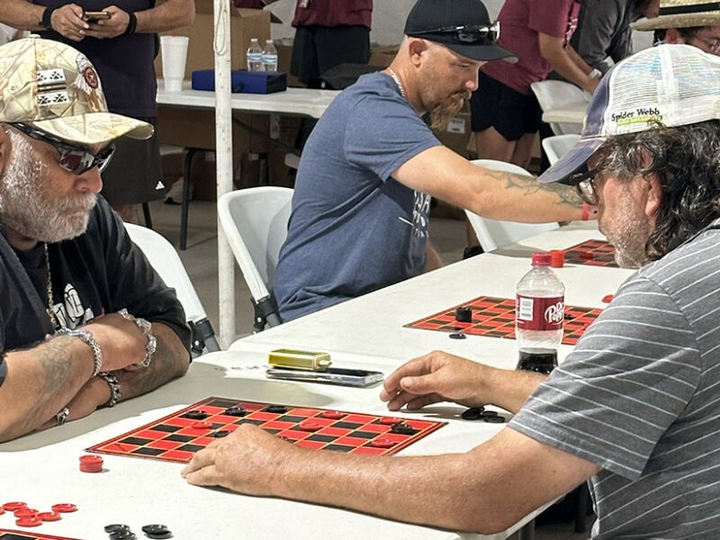 Two men play checkers