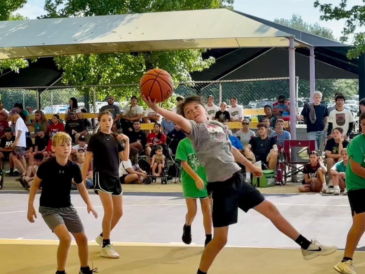 A young man rebounds the ball.