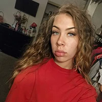 Young woman takes a selfie in red tshirt.