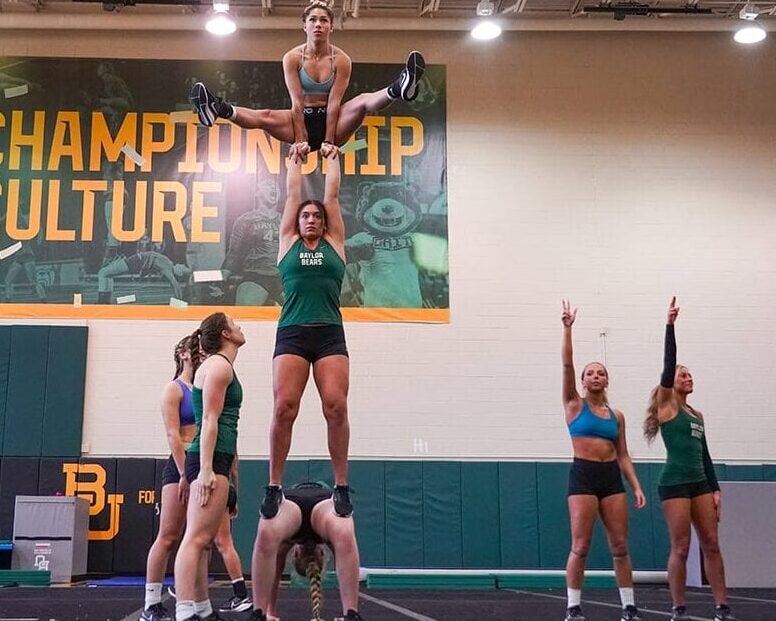 Young women perform a gymnastics routine.