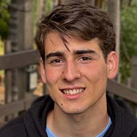 Young man smiles for photo.